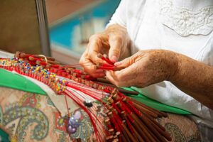 Carmen Gloria Flores’ colorful lace project requires dozens of bolillos to create. Photo by Rebecca L. Rhoades