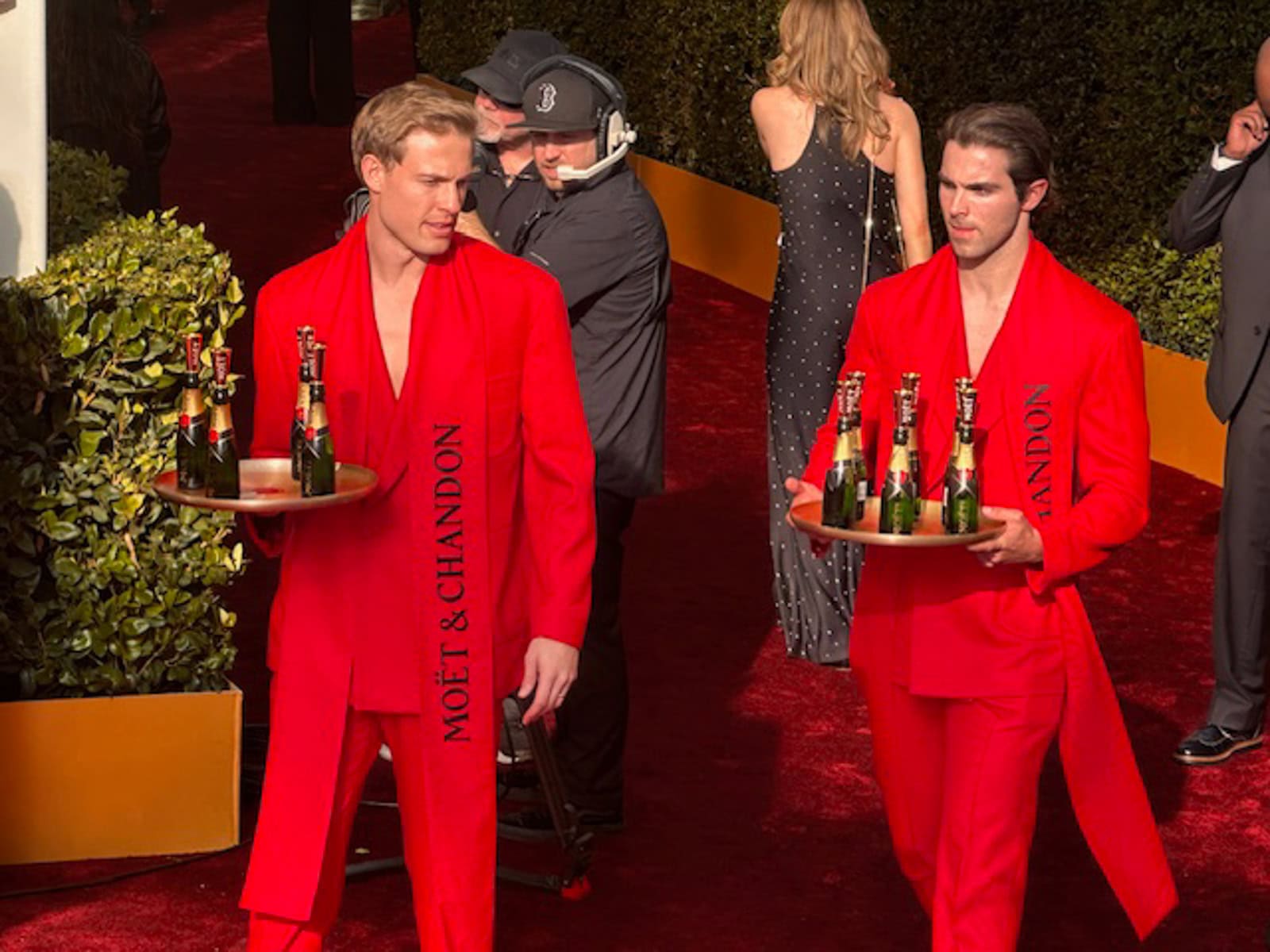 Red-dressed servers on the red carpet