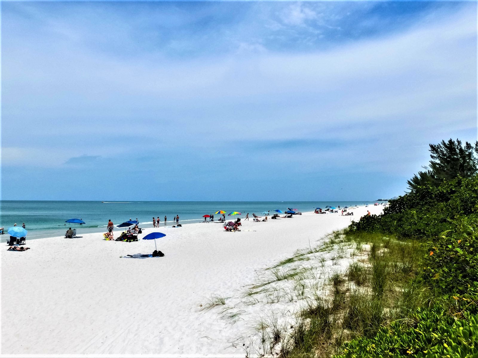 Tourists enjoying the Vanderbilt beach in Naples, Florida.