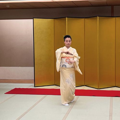 Young and beautiful,  this woman, now a professional geisha performs a song and fan dance.
